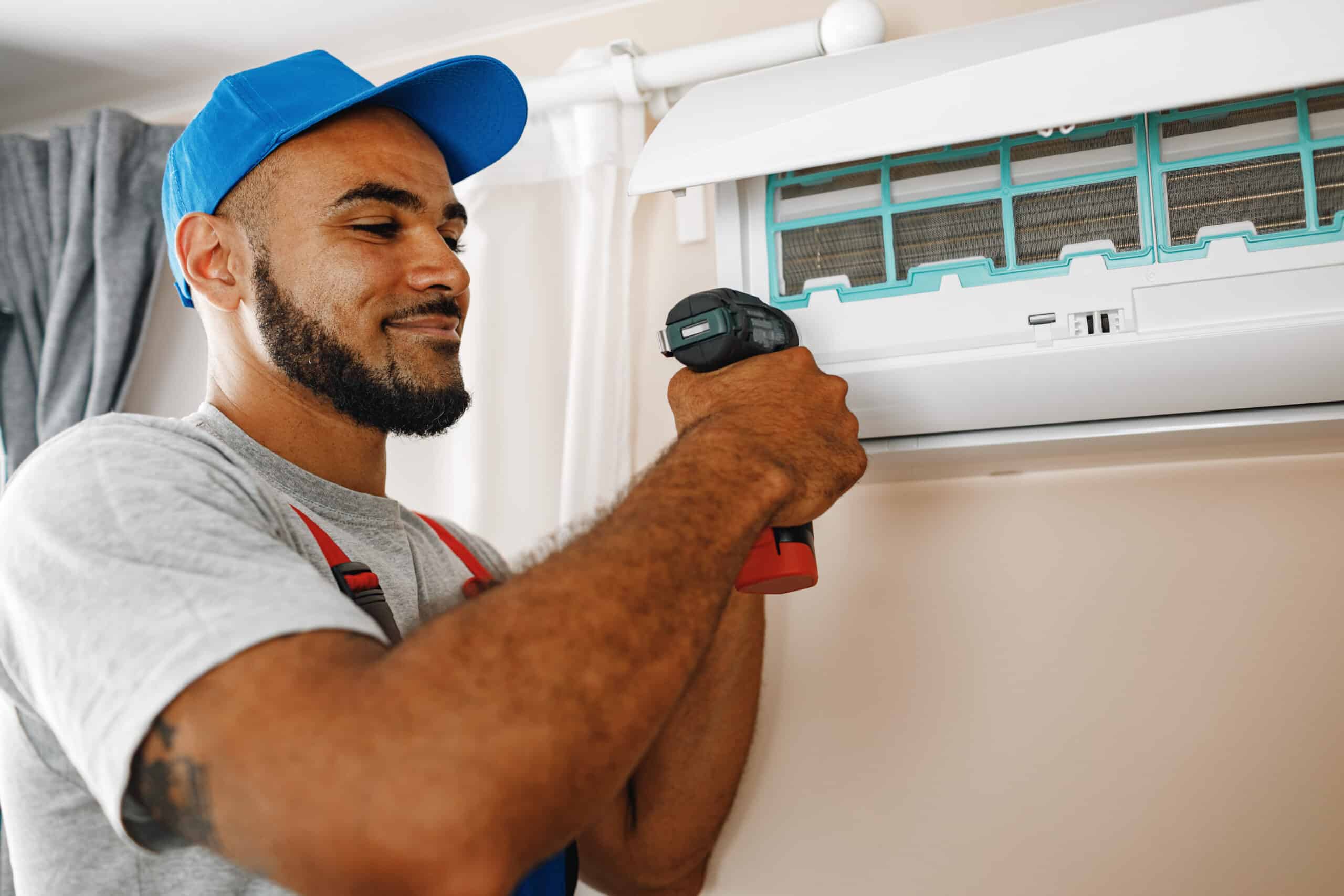 Professional repairman installing air conditioner in a room close up